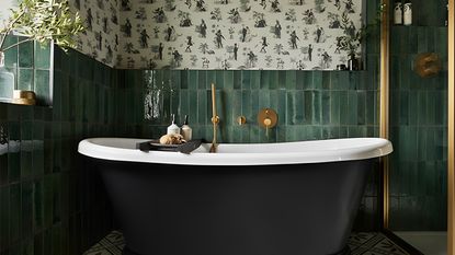 A green tiled bathroom with a gold shower and a black roll top bathtub