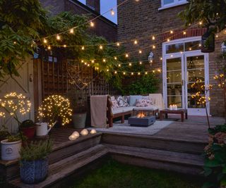 Outdoor festoon lights and statement decorative lights on a raised garden deck