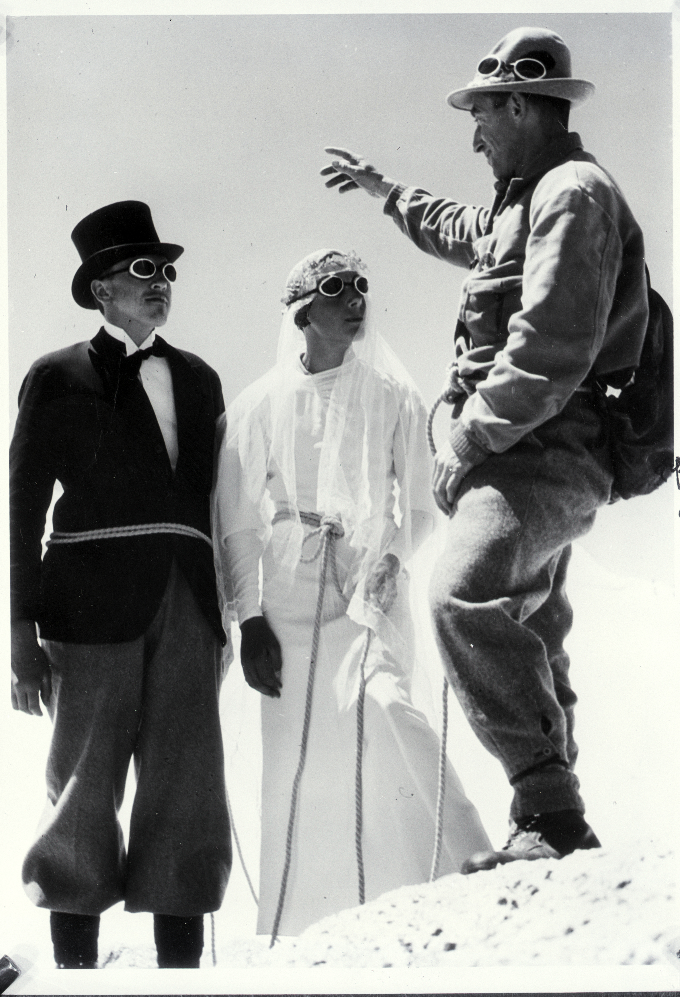 A man and woman wearing cool goggles being married on a ski slope