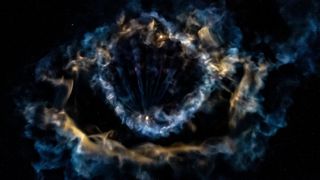 a ring-shaped cloud of multi-colored gas on a black background