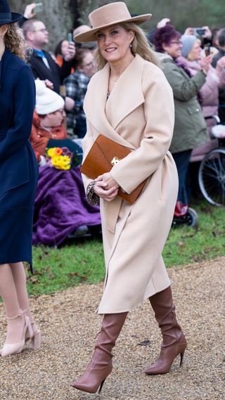 Duchess Sophie wearing brown knee high boots and a coat on Christmas Day 2022