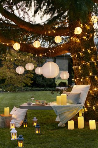 outdoor fairy lights, faux candles and decorative lighting at twilight for a romantic feel