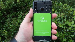 Teracube 2e held in one hand with its rear open