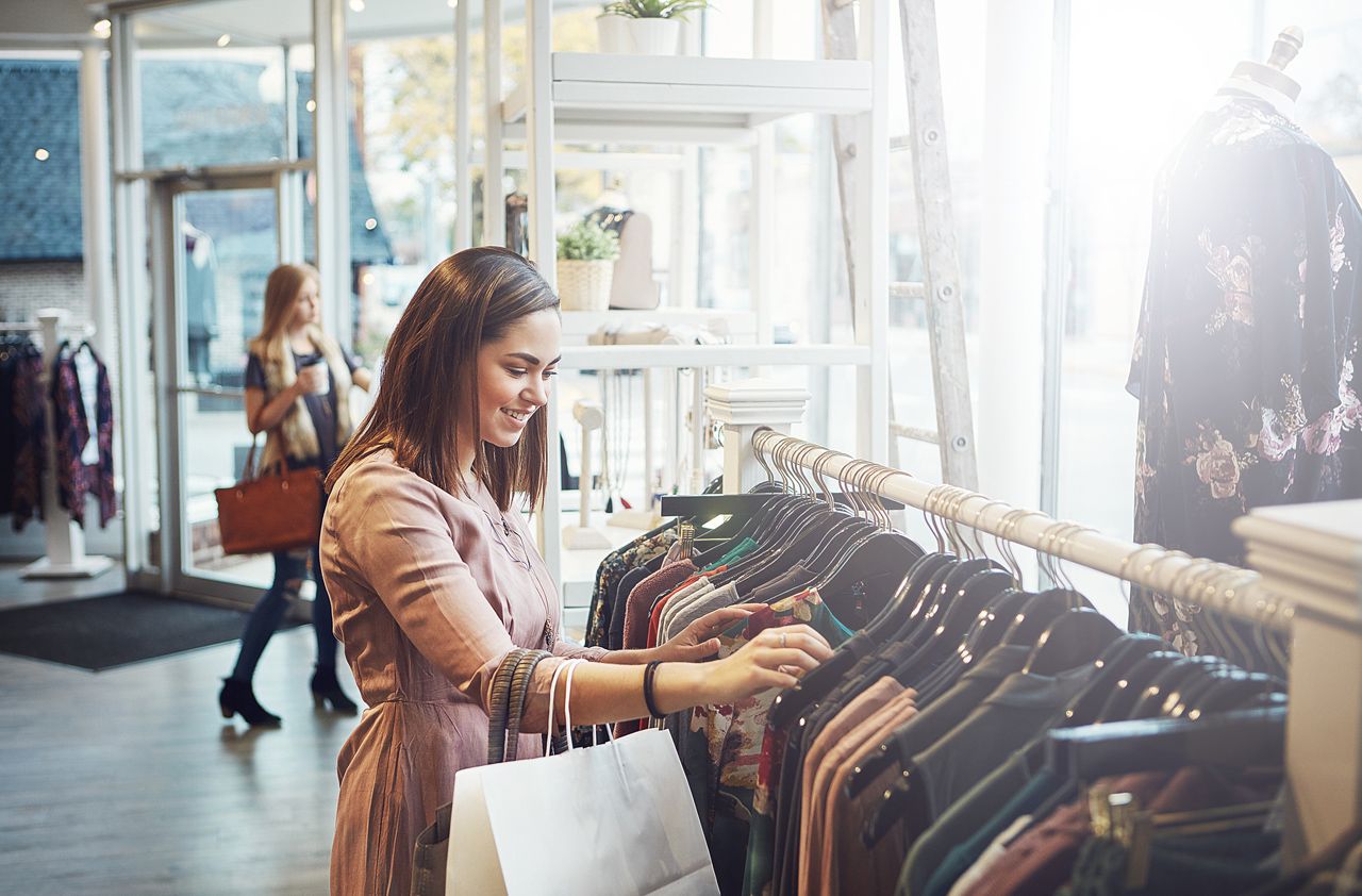 Shot of a young woman shopping at a clothing store