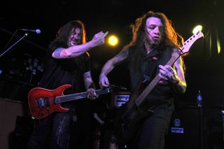 Dave "Snake" Sabo (left) and Scotti Hill perform onstage with Skid Row at the Manchester Academy in Manchester, England on October 24, 2013