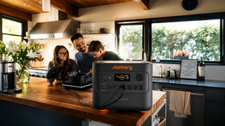 Family in kitchen cooking next to Jackery device