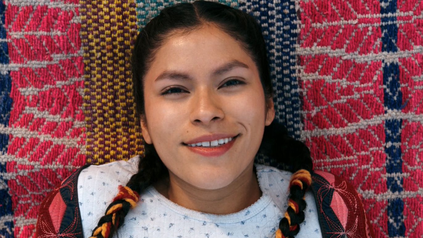 Kusimayu smiling after she's been converted to join The Others in Pluribus episode 9