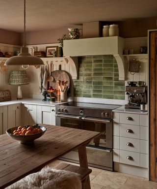 A cozy cottage kitchen with a green tile backsplash