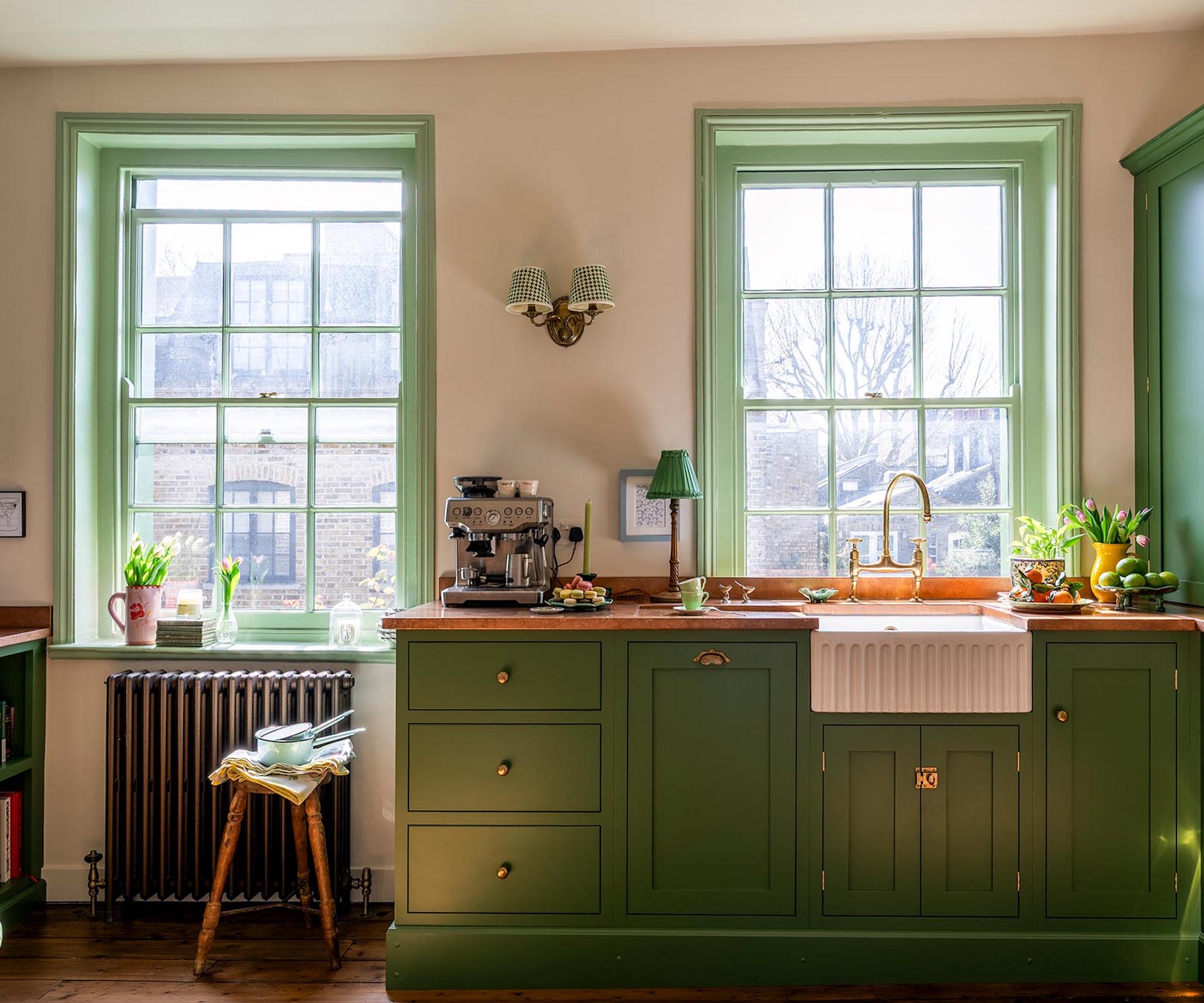kitchen with green cabinets and window frames