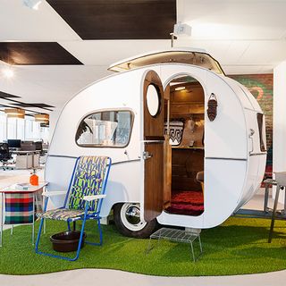 office with green grass carpet with white ceiling and cardboard box light