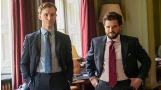 Robert (Harry Lawtey) and Henry (Kit Harington) wearing suits in an office setting in &quot;Industry&quot; season 3