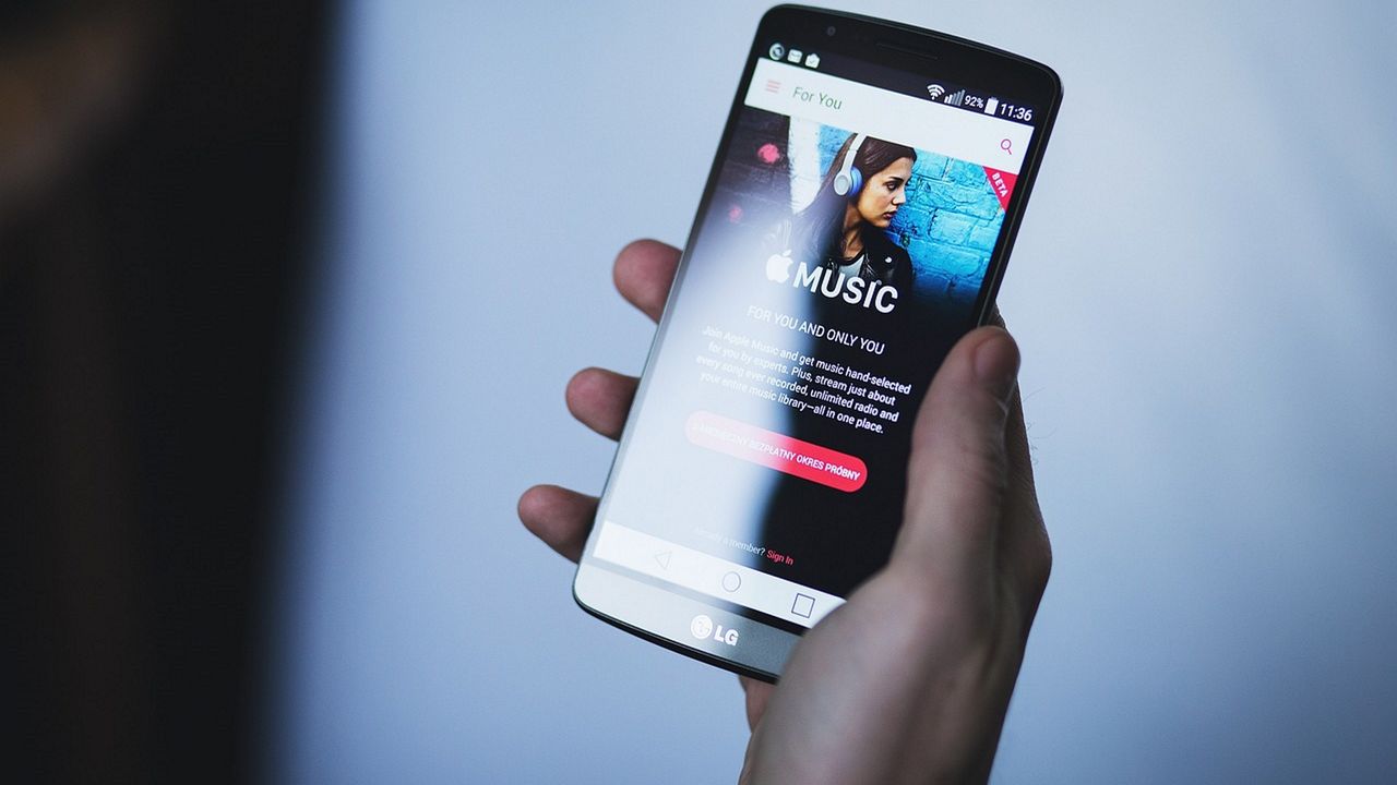 Apple Music displayed on LG phone in person&#039;s hand