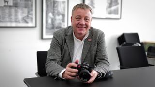 Leica VP of photo and technology, Stefan Daniel, holding a Leica SL3