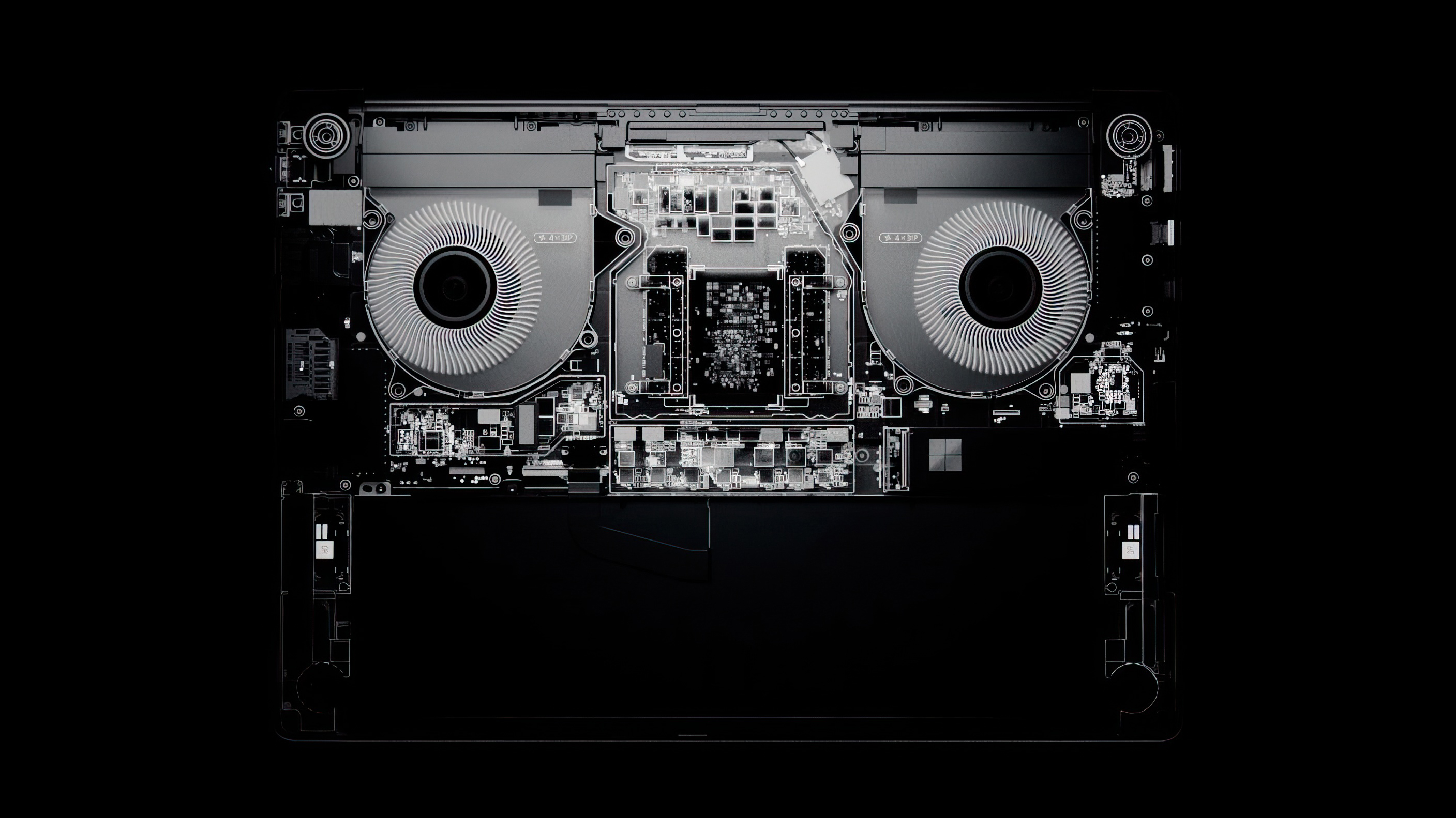 X-ray image of Surface Laptop Ultra interior with two prominent cooling fans and visible circuitry. The design is symmetrical, creating a high-tech, sleek look.