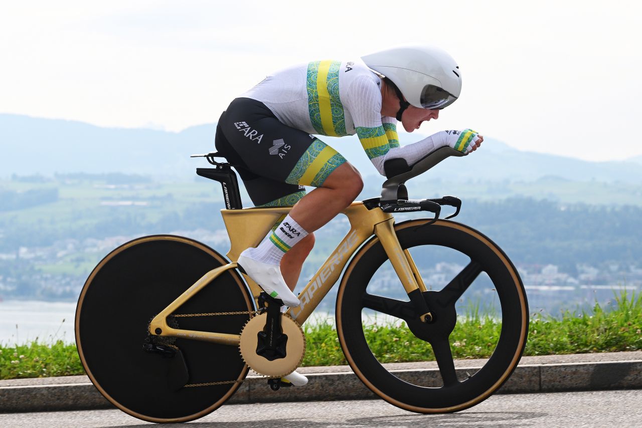 Grace Brown on a gold bike