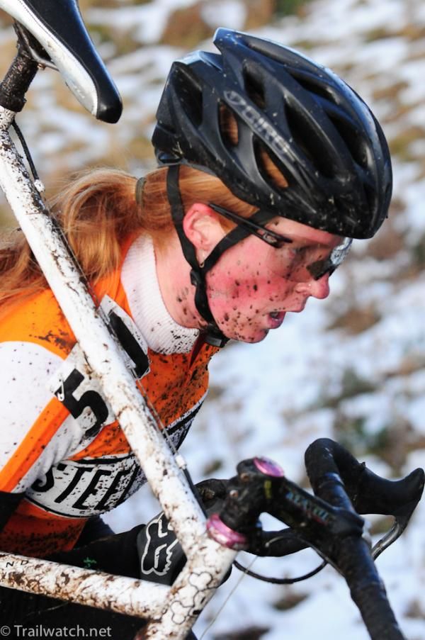 Megan Lawson shouldering her bike on a steep pitch