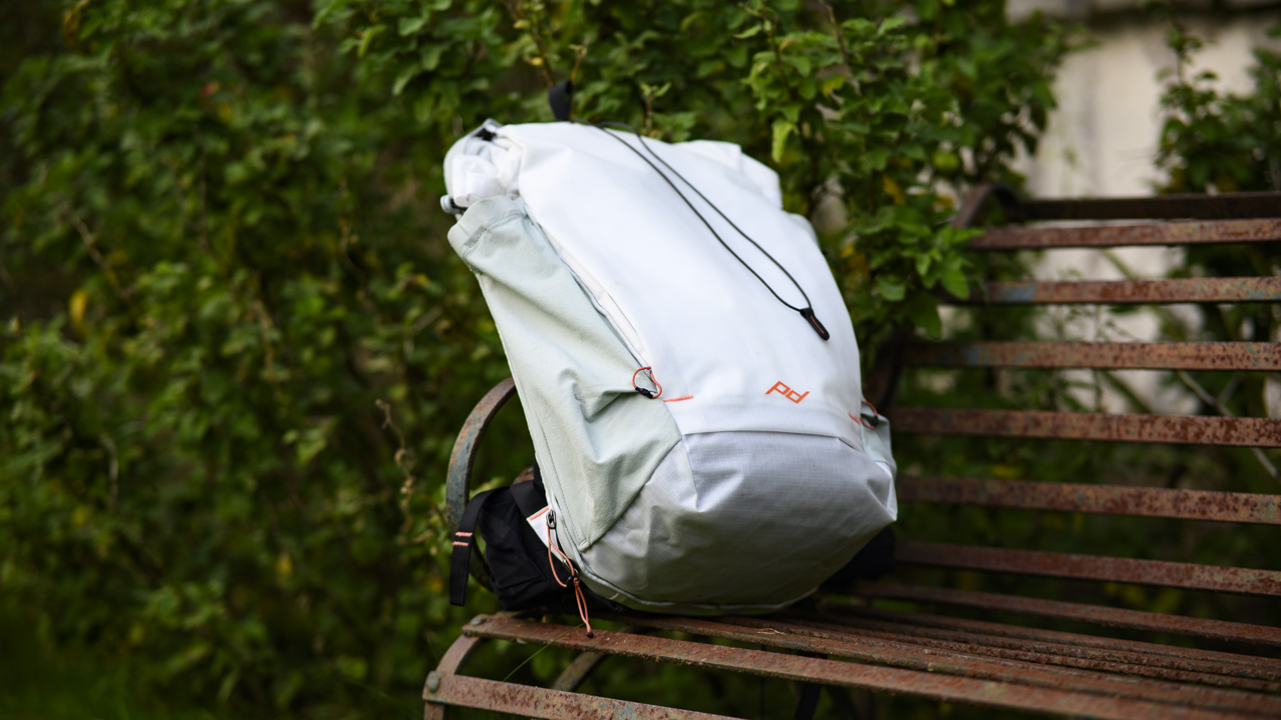 Peak Design Outdoor Backpack 25L in white, on a rustic bench