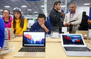 Shoppers looking at laptops. Credit: Getty Images