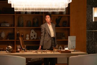 Julianne Nicholson as Samantha Redmond a.k.a. Sinatra, standing behind her office desk with figurines in front of her, in 'Paradise.'