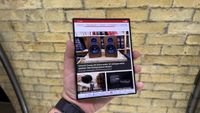 Samsung Galaxy Z Fold 8 and 8 Ultra in hand at a hands on event with a brick wall in the background