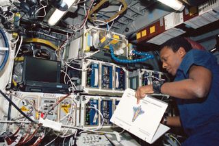 Astronaut Michael Anderson Reads a Checklist