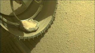 A view of the Mars rover Perseverance's pet rock in its left front wheel on Feb. 6, 2022.