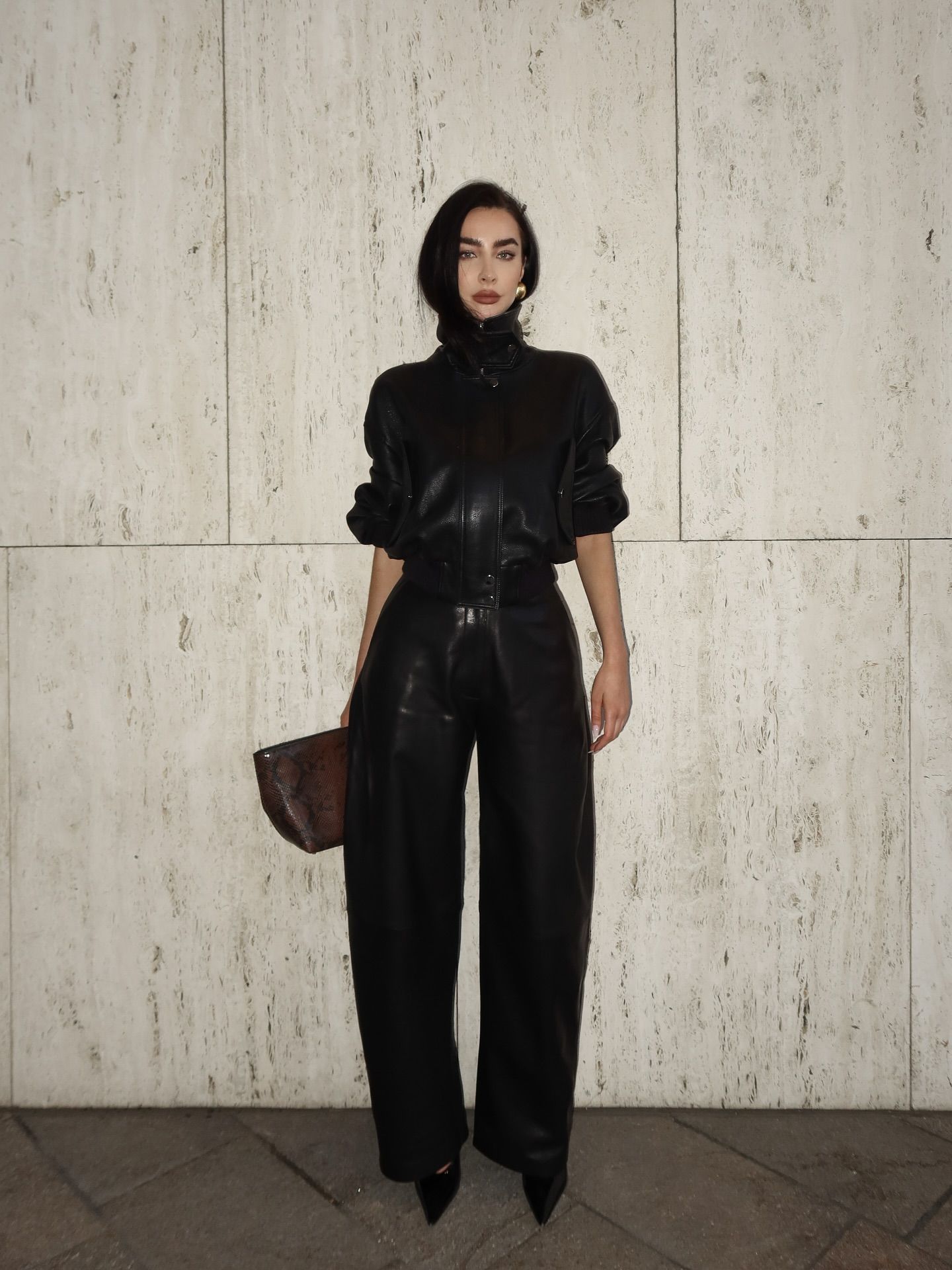 A woman wearing a fall leather-pant outfit in 2026.