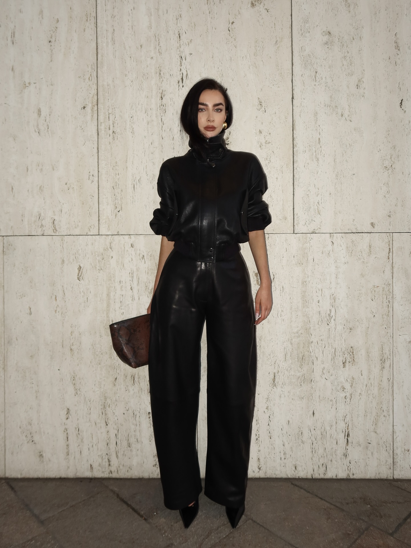 A woman wearing a fall leather-pant outfit in 2026.
