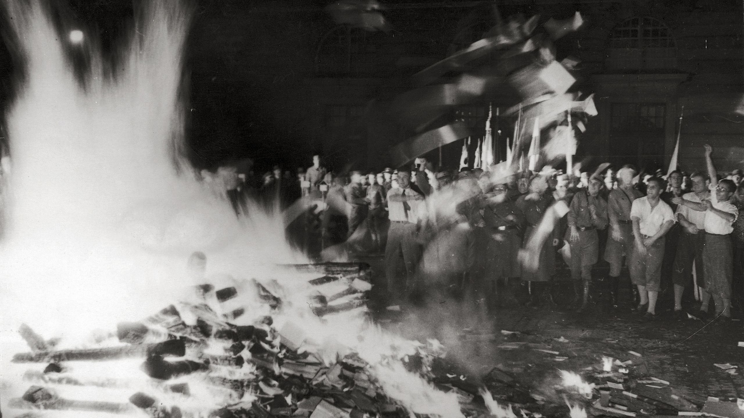 Flying books turn into ghostly streaks in this eerie 1933 photo, proving the power of shutter speed