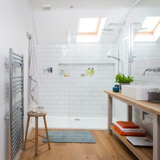 exterior of scandi house bathroom with vanity unit floor to ceiling tiling oversized mirrors and clear glass shower panel