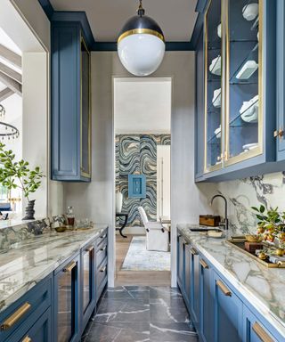 Chef's kitchen with blue cabinetry and marble suface