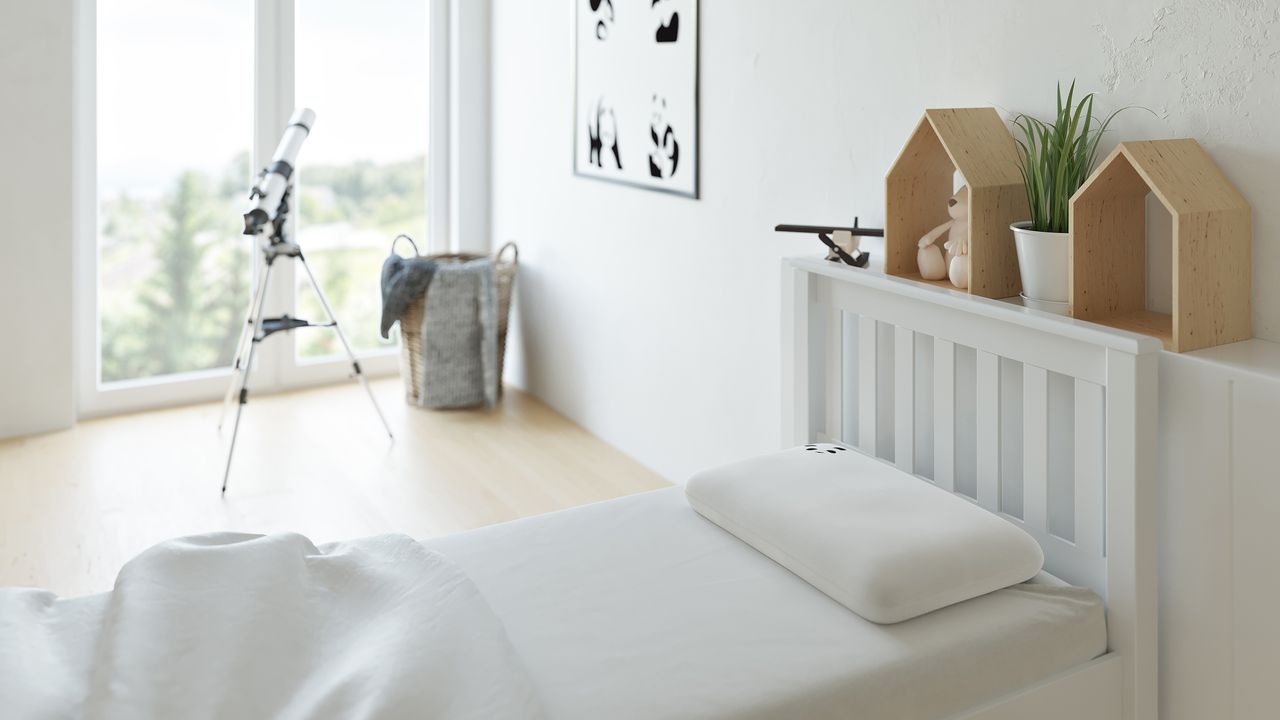 Panda pillows on kids bed in bedroom.