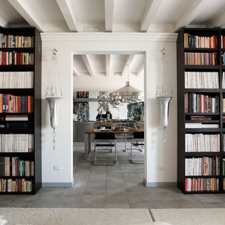 hallway with book shelf and white wall