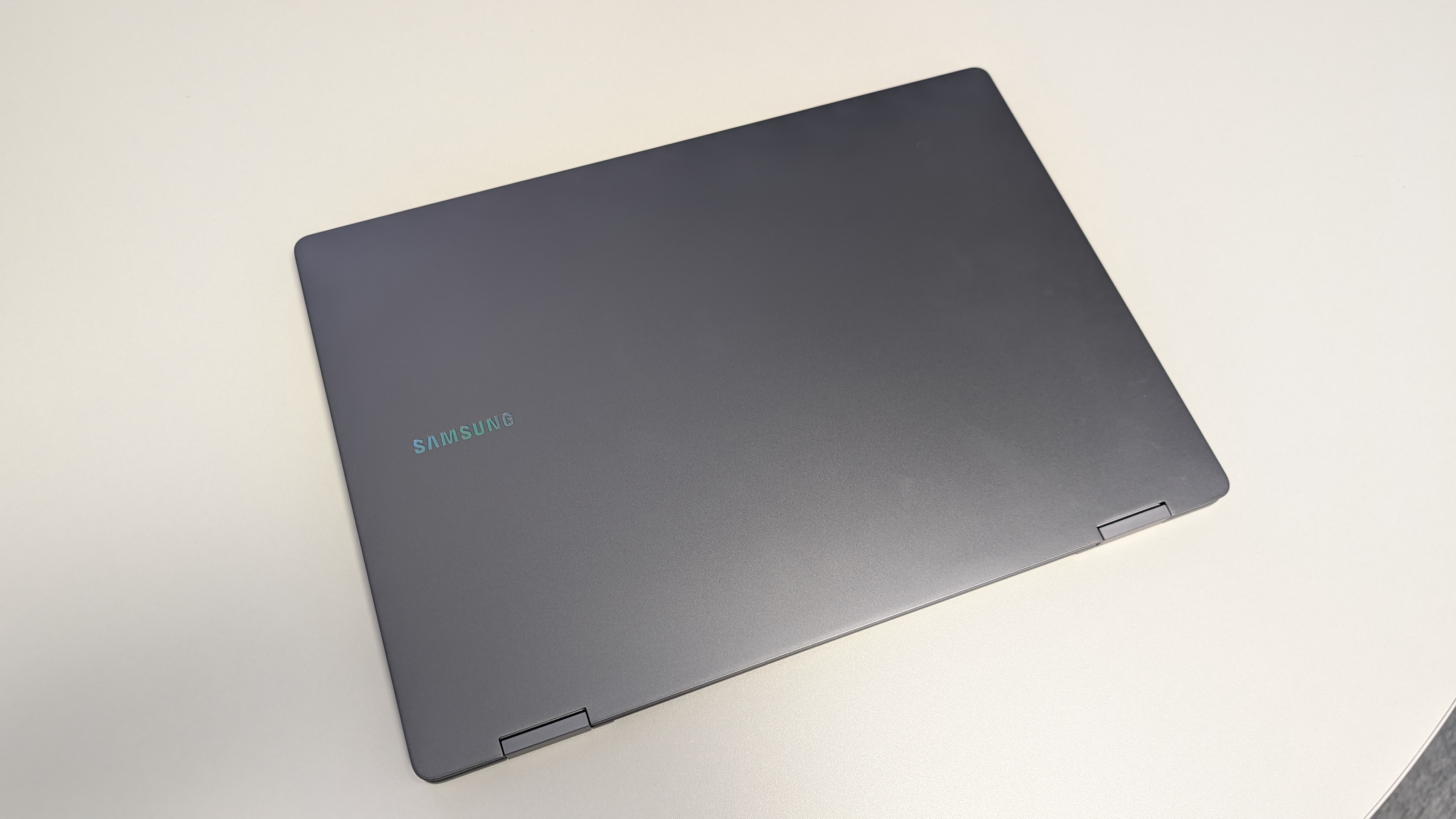 The Samsung Galaxy Book5 Pro 360 photographed on a white desk.