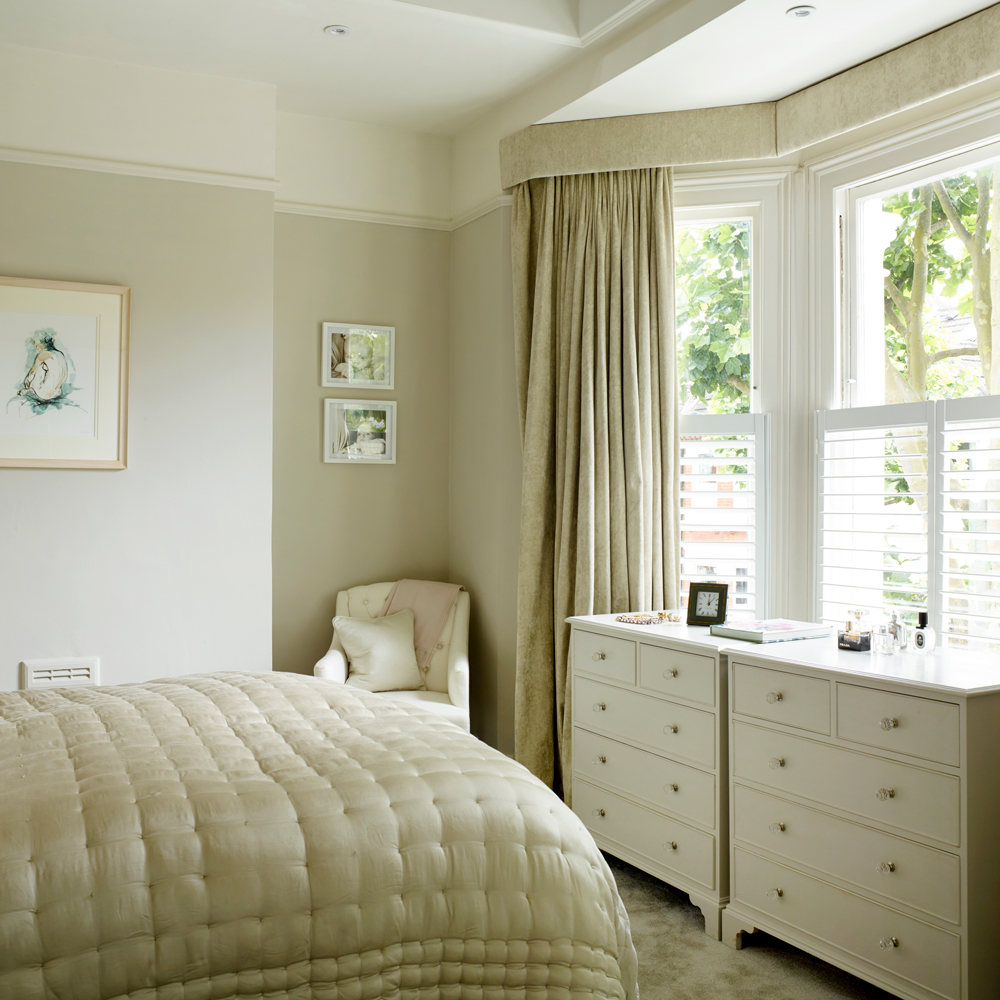 bedroom with white window and watch on white storage table