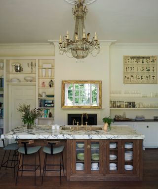 White kitchen with dark wooden island and marble top