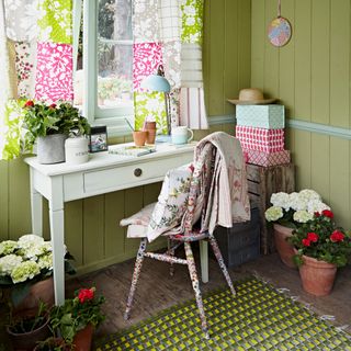 garden office with yellow walls and flower pots