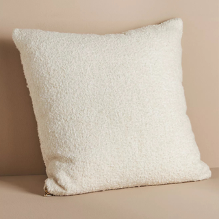 A cream boucle throw pillow