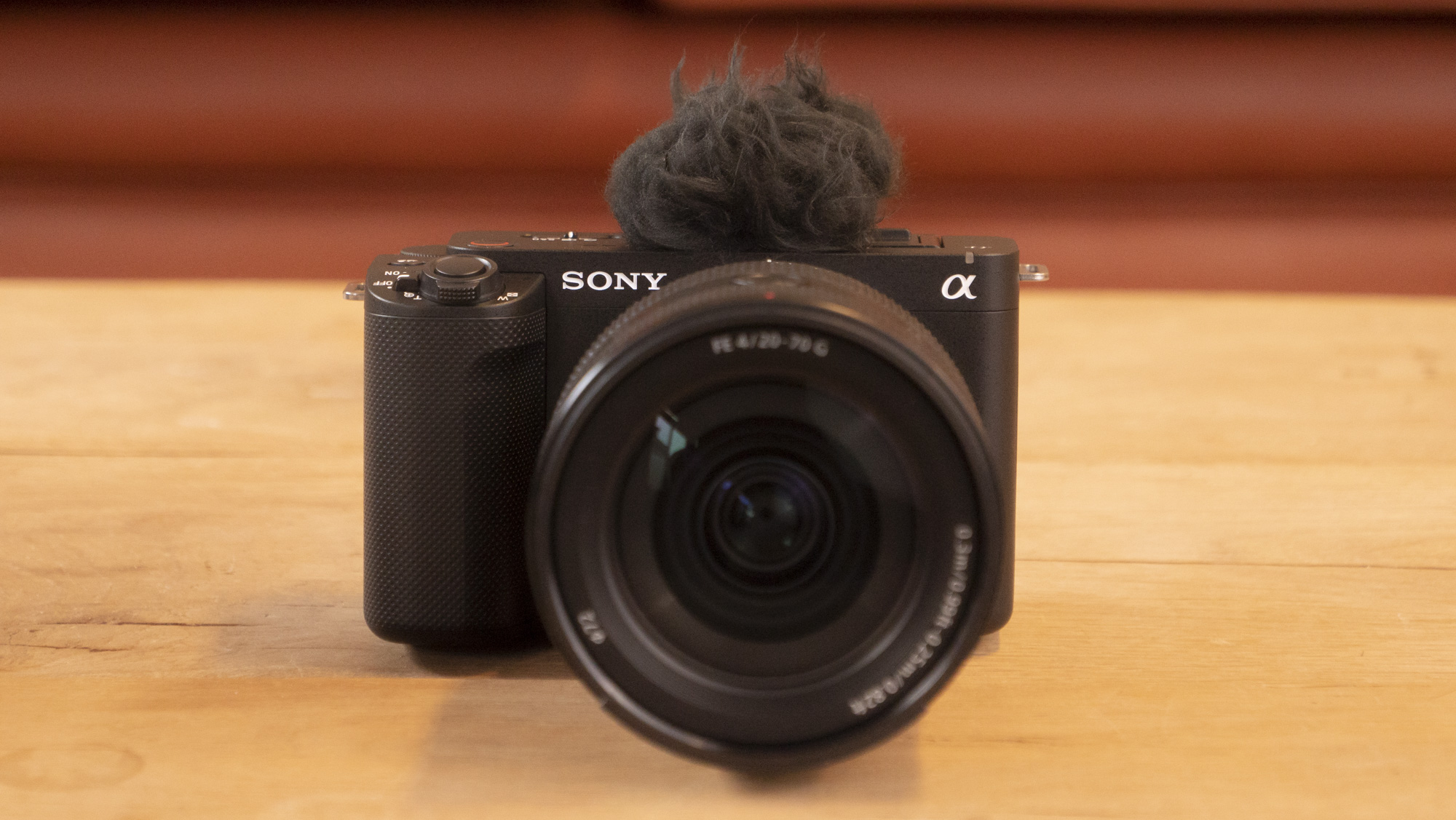 The Sony ZV-E1 camera sitting on a wooden table