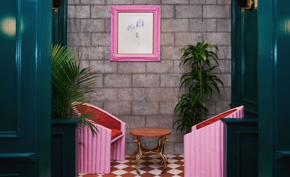 Room with 2 pink chairs and 1 pink frame