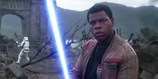John Boyega as Finn with lightsaber in Star Wars: The Force Awakens