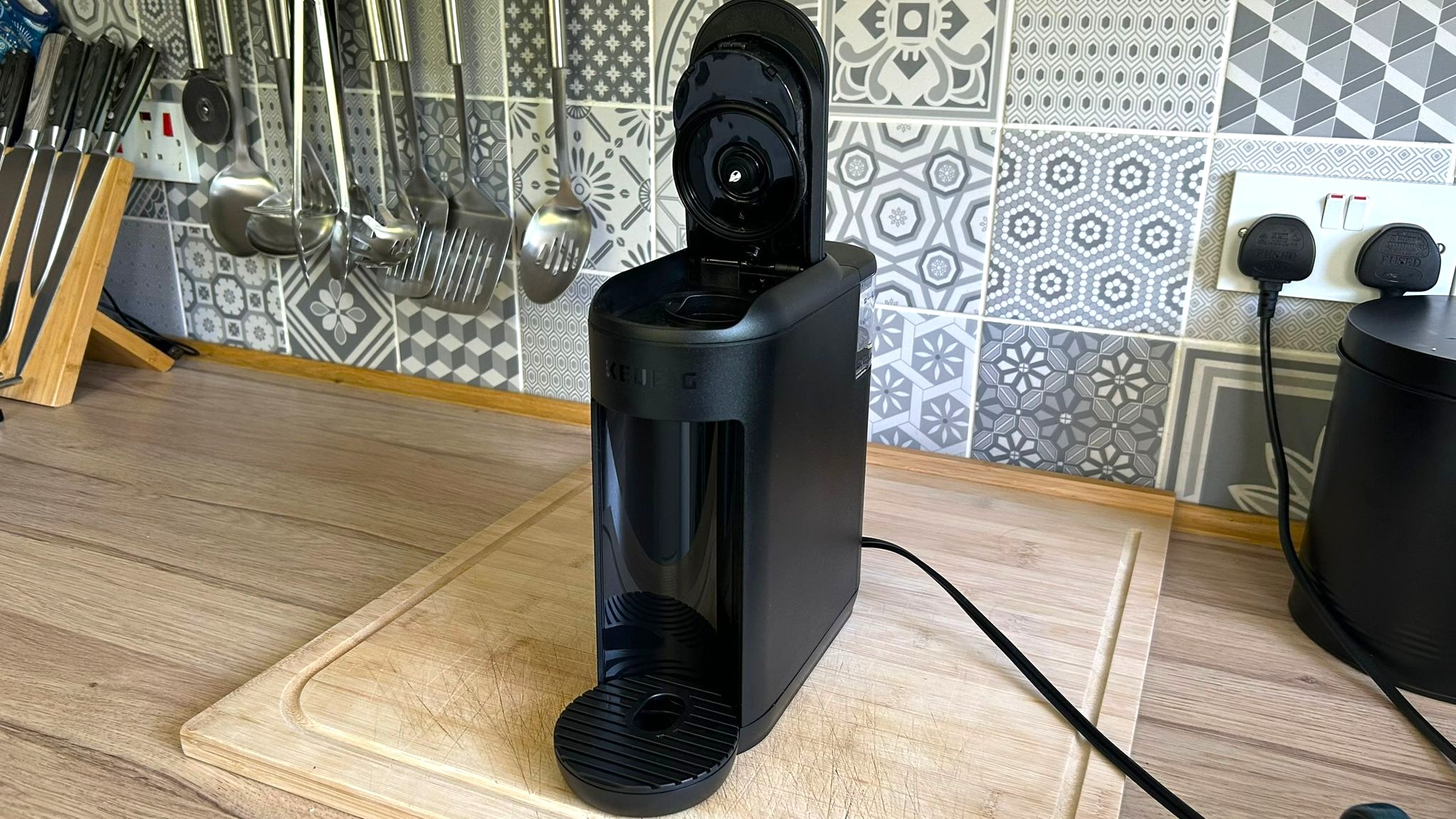 Keurig K-Mini Mate coffee maker on kitchen counter with lid open