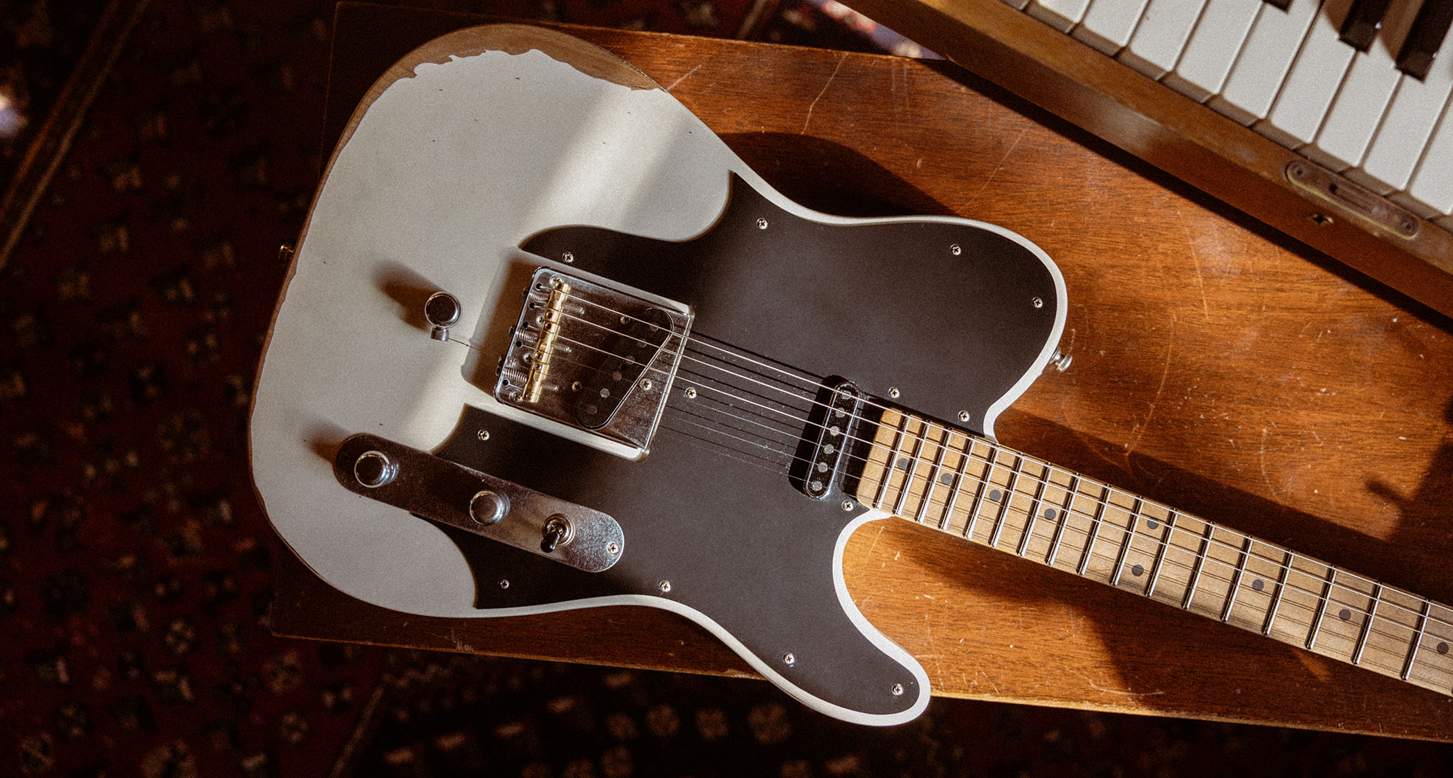 The Fender John Osborne Telecaster comes factory modded with a B-Bender and has an extended black pickguard on a Road Worn Olympic White body.