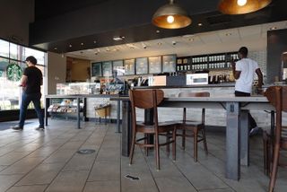 People visit a Starbucks coffee store as the company reported supply shortages at some coffee shops on June 11, 2021 in Miami, Florida.