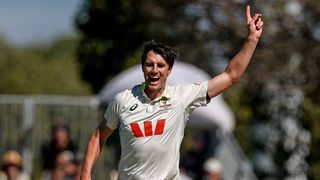 Pat Cummins raises his finger in the air after claiming a Test wicket for Australia.
