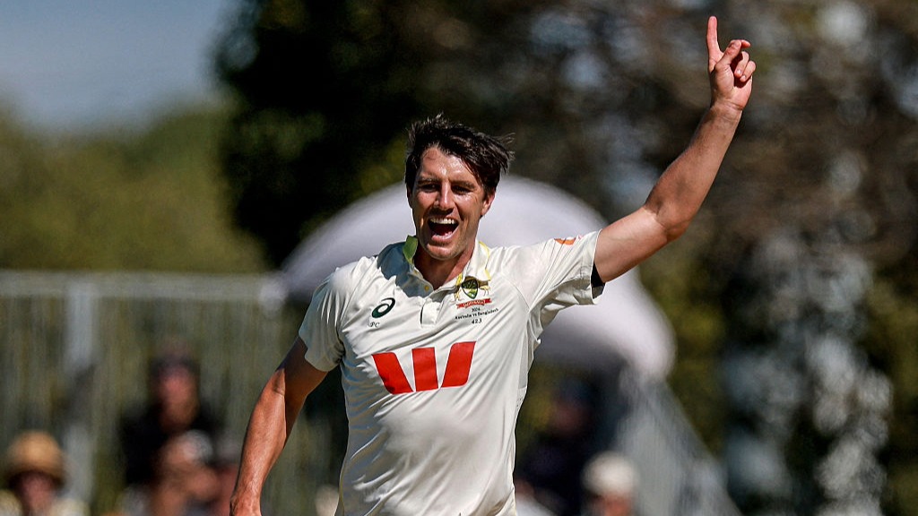 Pat Cummins raises his finger in the air after claiming a Test wicket for Australia.