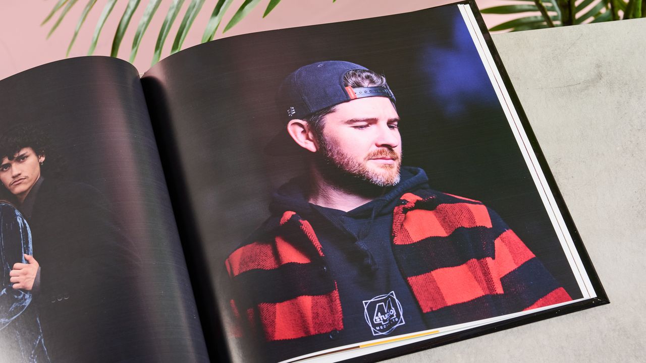 Man with backwards cap looking down in Printerpix photo book