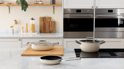 new smeg cookware launch with three cream-colored pots and pans
