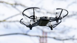 Ryze Tello beginner drone flying past a tree