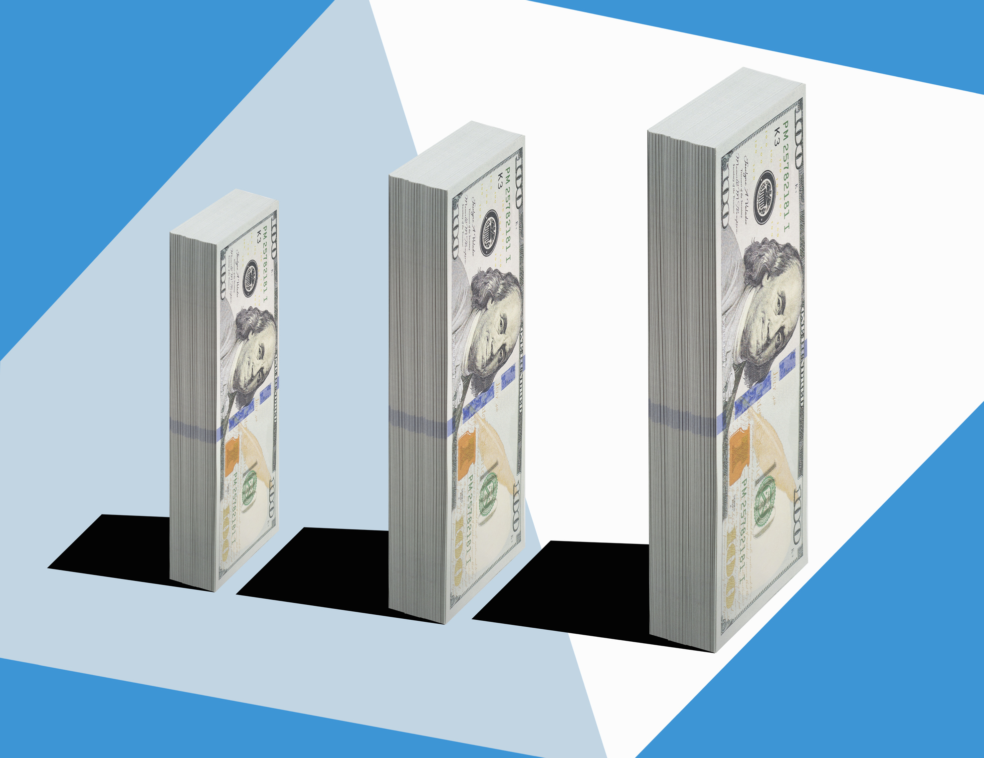 3 bundles of US $100 bills of various size standing vertically in ascending order, on blue and white patterned surface